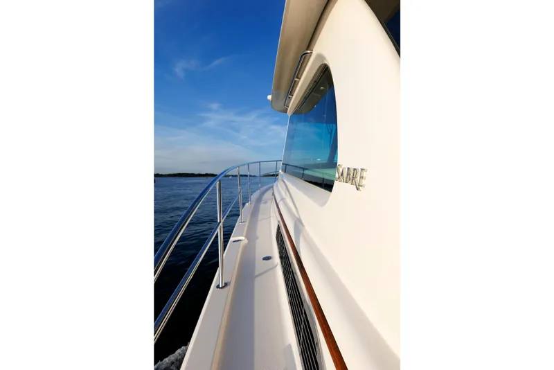 Slide: The Image of 2022 Sabre 38 SE yacht cruising on calm waters under a clear blue sky. - 41