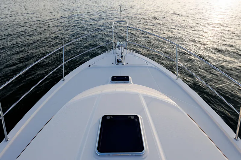 Slide: The Image of Bow view of 2022 Sabre 38 SE yacht on calm water. - 42