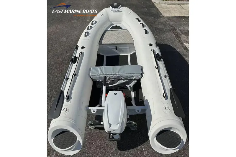 Slide: The Image of Manufacturer Provided Image: Inflatable East Marine 300 boat, 2026 model, with motor and seating, on pavement. - 4