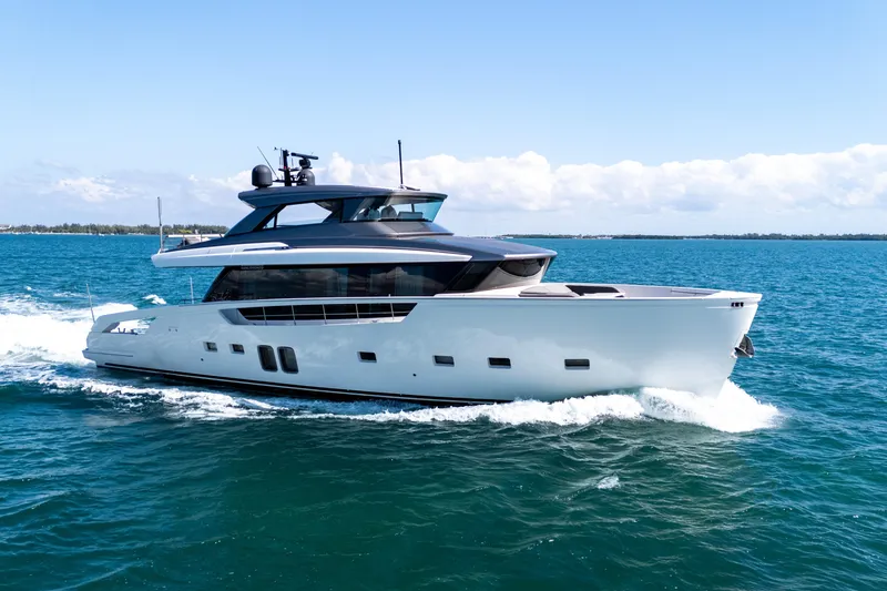 The Image of 2019 Sanlorenzo SX76 yacht cruising on open sea under clear blue sky. - 0