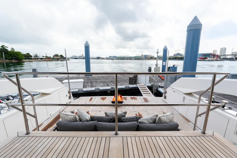 Slide: The Image of Luxurious 2019 Sanlorenzo SX76 yacht deck with modern seating and city skyline view. - 27