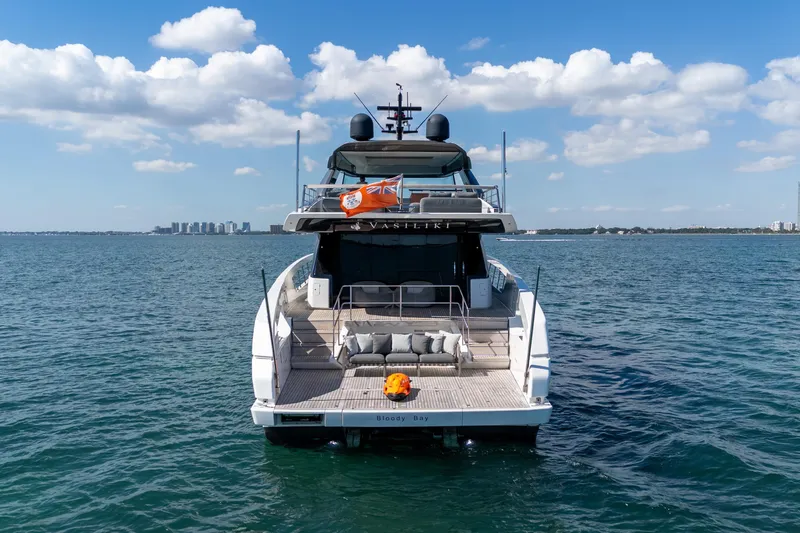 Slide: The Image of 2019 Sanlorenzo SX76 yacht on open water, rear view with city skyline. - 4