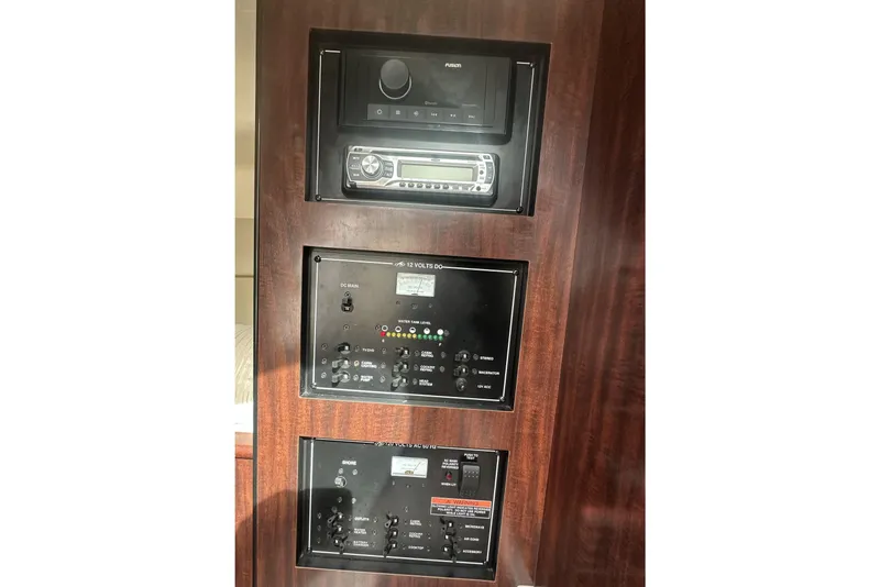 Slide: The Image of Control panel of 2016 Monterey 295 Sport Yacht with audio system and switches. - 12