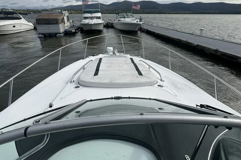 Slide: The Image of 2016 Monterey 295 Sport Yacht docked with scenic mountain backdrop. - 4