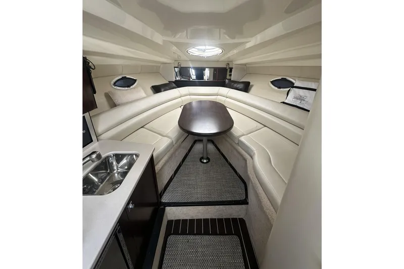 Slide: The Image of Interior of 2016 Monterey 295 Sport Yacht with seating, table, and kitchenette. - 8