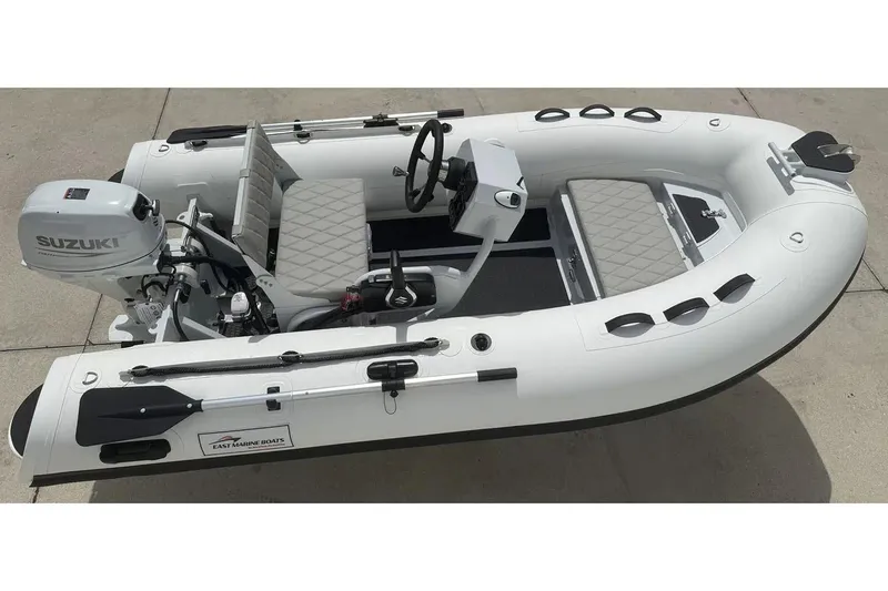 Slide: The Image of Manufacturer Provided Image: 2025 East Marine 320 inflatable boat with motor and steering wheel, viewed from above. - 4