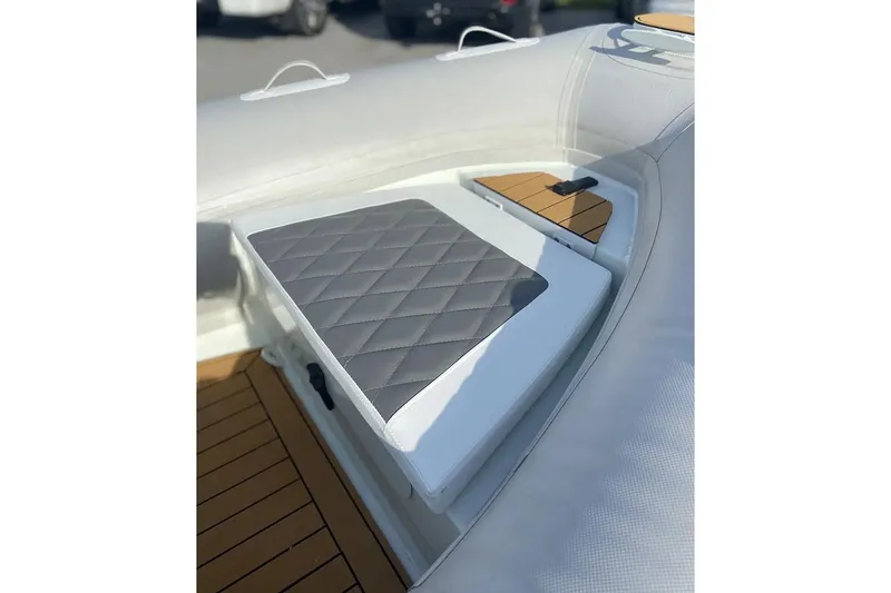 Slide: The Image of Manufacturer Provided Image: 2025 East Marine 360 boat interior with cushioned seating and wooden flooring. - 11