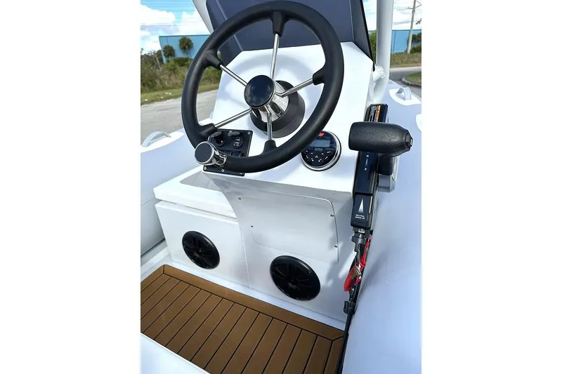 Slide: The Image of Manufacturer Provided Image: 2025 East Marine 360 boat steering console with modern controls and wooden flooring. - 12