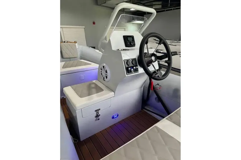 Slide: The Image of Interior of 2026 East Marine 360 boat with modern steering and control panel. - 15