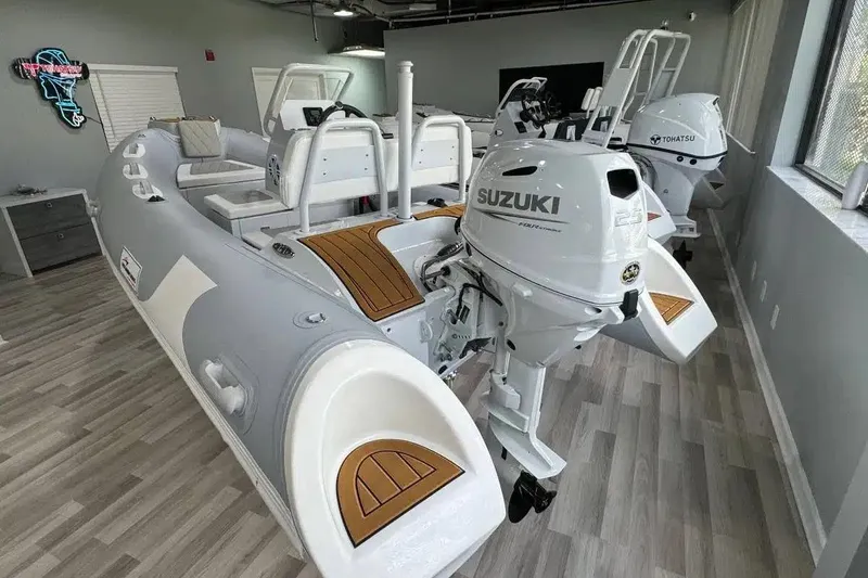 Slide: The Image of 2026 East Marine 360 boat with Suzuki outboard motor in showroom. - 3