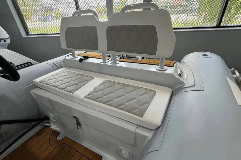 Slide: The Image of 2026 East Marine 360 boat interior with cushioned seating and storage compartment. - 8