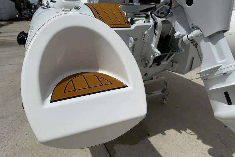 Slide: The Image of Showroom display of 2026 East Marine 390 LUXURY inflatable boats on wooden flooring. - 13