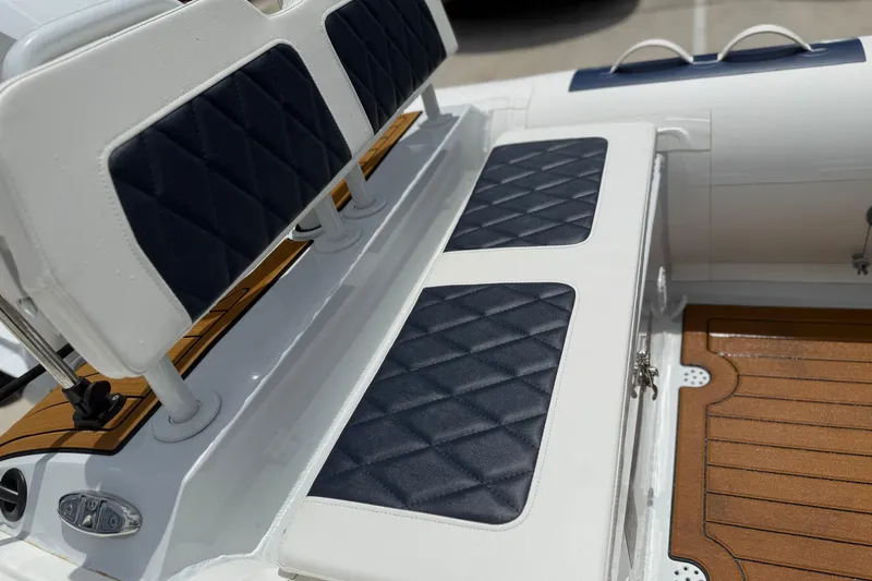 Slide: The Image of Warehouse filled with East Marine 390 LUXURY boats, 2026 model, under bright lighting. - 15