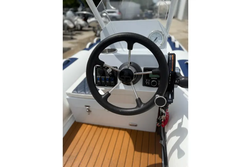 Slide: The Image of Group posing with East Marine 390 LUXURY boat at outdoor event, 2026 model. - 16