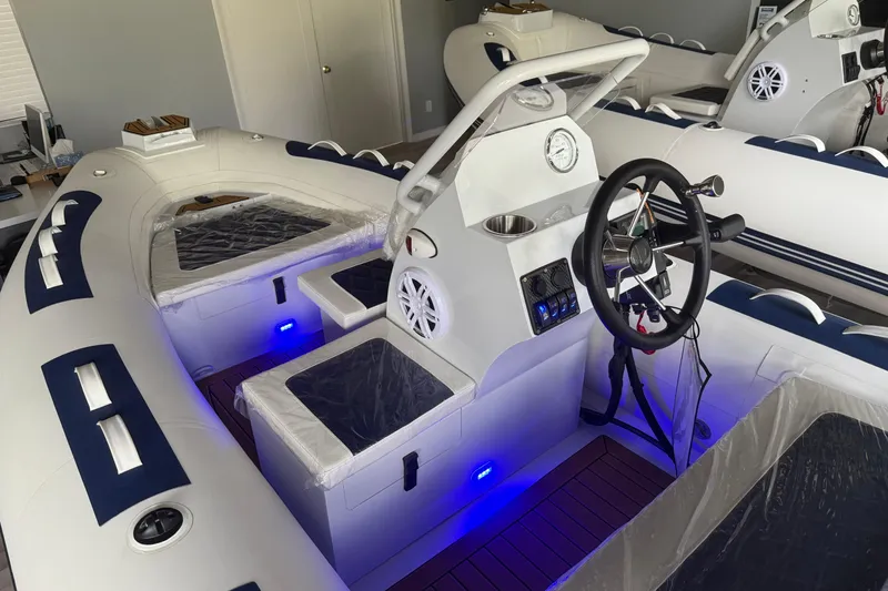 Slide: The Image of 2026 East Marine 390 LUXURY boat interior with modern dashboard and blue LED lighting. - 2
