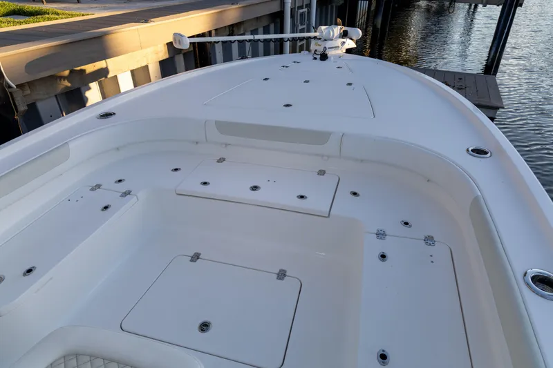 Slide: The Image of 2022 Caymas 28 HB Twin boat deck with storage compartments and fishing rod holders. - 12