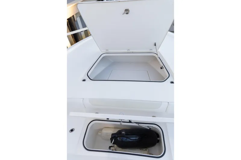 Slide: The Image of 2022 Caymas 28 HB Twin boat storage compartments, open and empty, showcasing interior space. - 17