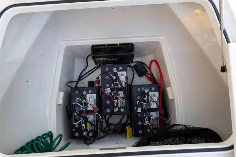 Slide: The Image of Battery compartment of 2022 Caymas 28 HB Twin boat with wiring and charger. - 19