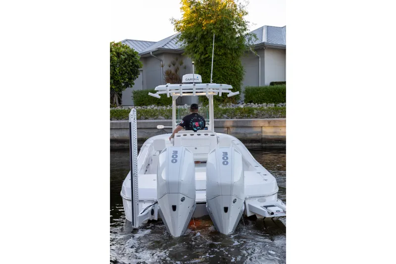 Slide: The Image of 2022 Caymas 28 HB Twin boat with dual engines on a calm waterway. - 27
