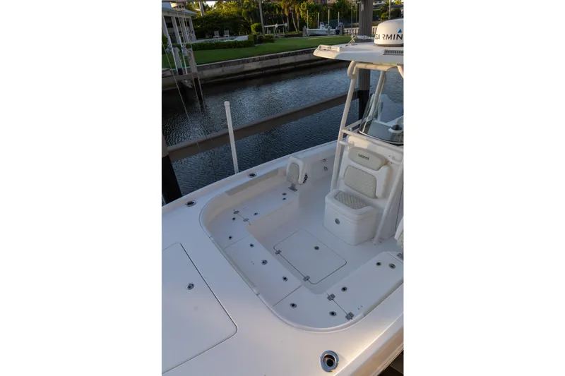 Slide: The Image of 2022 Caymas 28 HB Twin boat deck with seating, docked by a canal. - 4