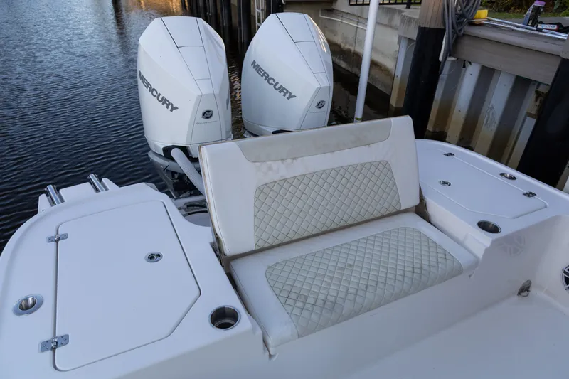 Slide: The Image of 2022 Caymas 28 HB Twin boat with dual Mercury engines and cushioned seating. - 6