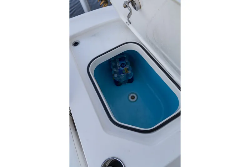 Slide: The Image of Storage compartment on 2022 Caymas 28 HB Twin boat with water bottles inside. - 7