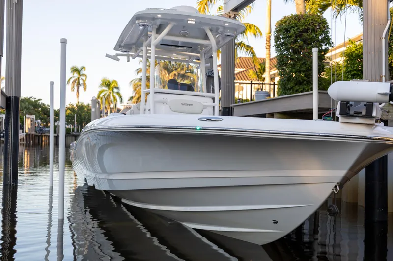 Slide: The Image of 2022 Caymas 28 HB Twin boat docked near palm trees. - 9
