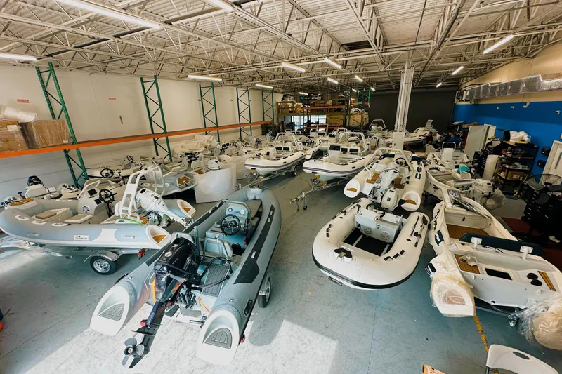 Slide: The Image of Showroom of East Marine 420 LUXURY boats, 2026 models, in a spacious warehouse setting. - 12