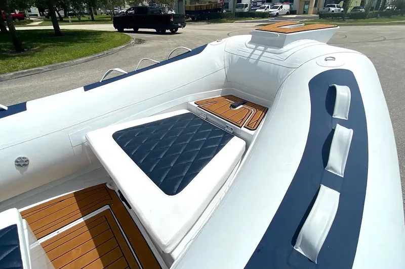 Slide: The Image of Manufacturer Provided Image: 2025 East Marine 420 boat interior with cushioned seating and wood accents. - 3