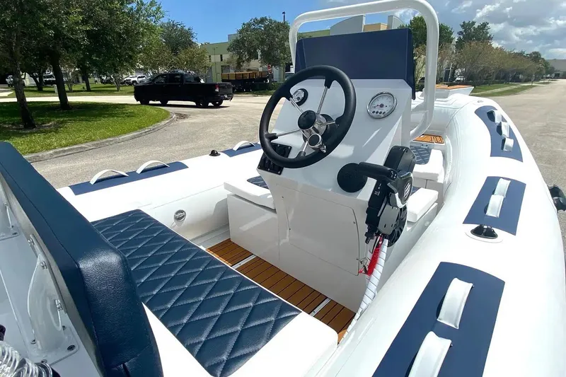 Slide: The Image of Manufacturer Provided Image: 2025 East Marine 420 boat interior with steering wheel, blue seating, and control panel. - 4