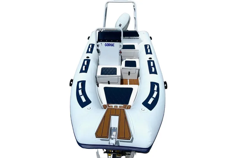 Slide: The Image of Manufacturer Provided Image: 2025 East Marine 420 boat, white with blue accents, featuring cushioned seating and storage compartments. - 6