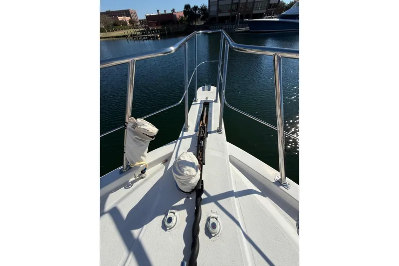 Slide: The Image of 1991 Californian 55 Cockpit Motor Yacht docked with boarding ladder and welcome mat. - 12