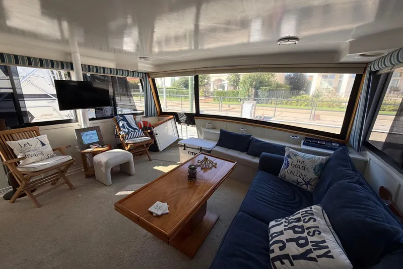 Slide: The Image of 1991 Californian 55 Cockpit Motor Yacht docked, showing side view and entrance. - 16