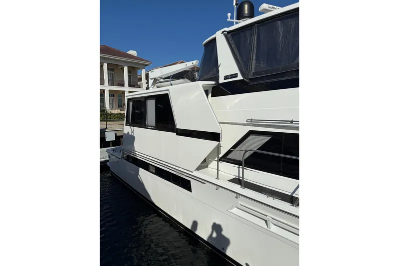Slide: The Image of 1991 Californian 55 Cockpit Motor Yacht docked under clear blue sky. - 3