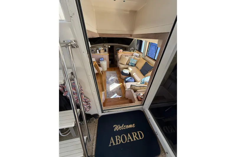 Slide: The Image of Interior of 1991 Californian 55 Cockpit Motor Yacht with white seating and nautical decor. - 33