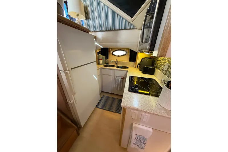 Slide: The Image of Narrow hallway inside 1991 Californian 55 Cockpit Motor Yacht with wooden paneling and modern decor. - 51