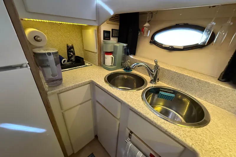 Slide: The Image of Luxurious bedroom in 1991 Californian 55 Cockpit Motor Yacht with teal bedding and wood accents. - 54