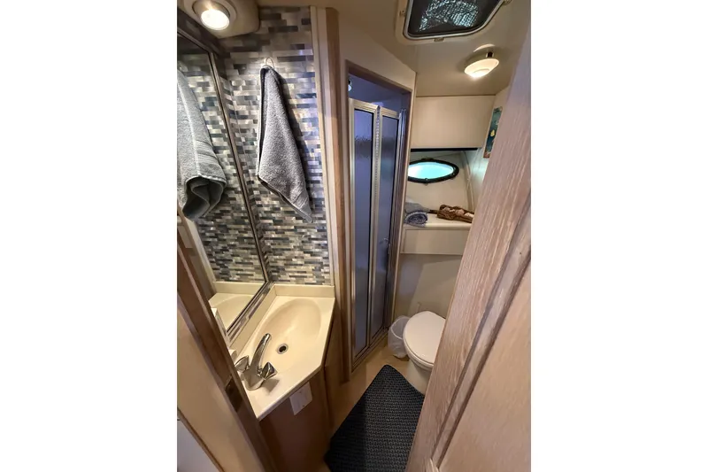 Slide: The Image of Interior of 1991 Californian 55 Cockpit Motor Yacht with wooden stairs and cozy dining area. - 57