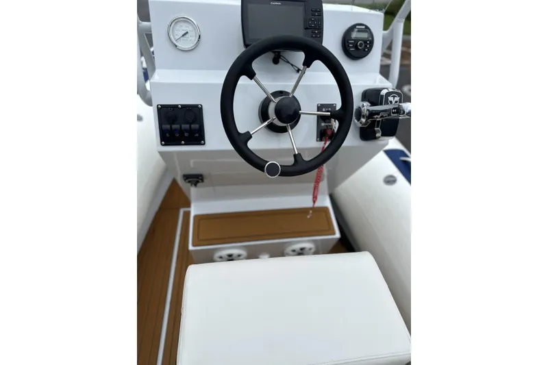Slide: The Image of Steering console of 2026 East Marine 560 boat with modern controls and gauges. - 11