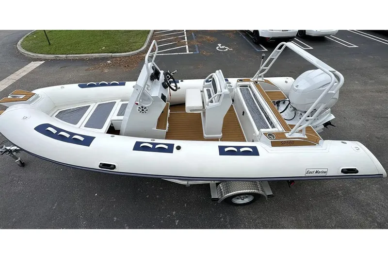 Slide: The Image of Manufacturer Provided Image: 2025 East Marine 560 inflatable boat on trailer, featuring sleek design and modern controls. - 2