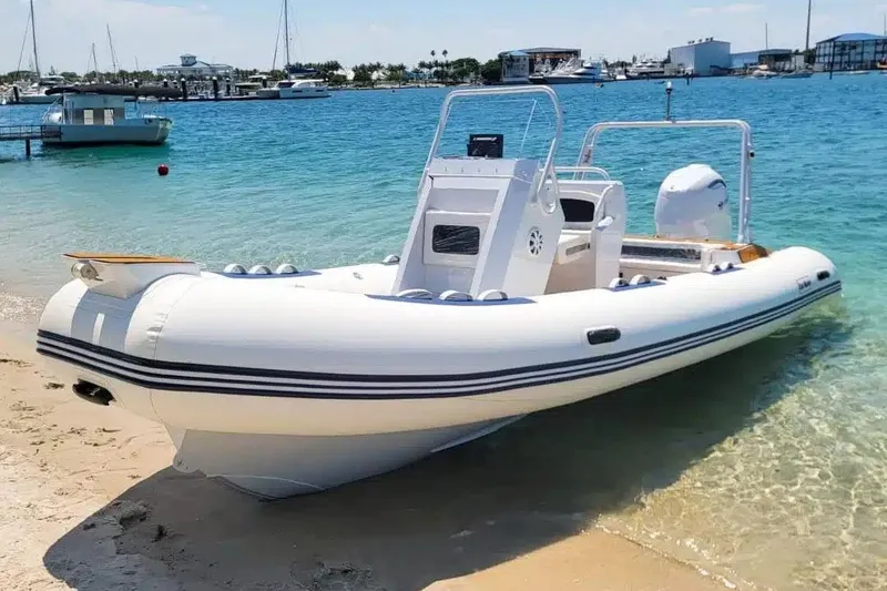 Slide: The Image of Manufacturer Provided Image: 2025 East Marine 560 boat on sandy beach with clear blue water background. - 3