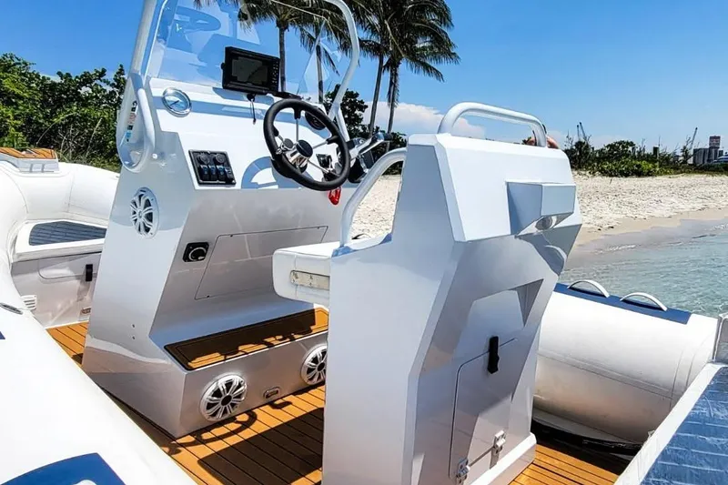 Slide: The Image of Modern East Marine 560 boat interior, 2026 model, with steering console on a sunny beach. - 4