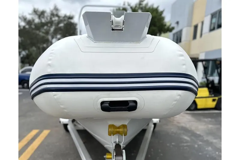 Slide: The Image of Manufacturer Provided Image: 2025 East Marine 560 inflatable boat on trailer, front view. - 9