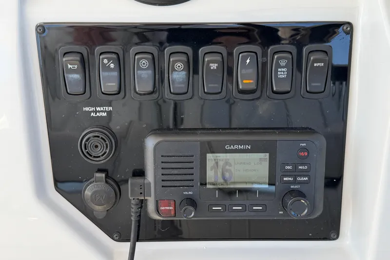 Slide: The Image of Control panel of 2021 Regal 33 SAV boat with Garmin system and switches. - 16