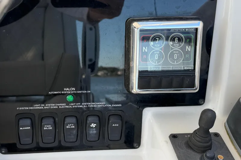 Slide: The Image of Control panel of 2021 Regal 33 SAV boat with joystick and switches. - 17