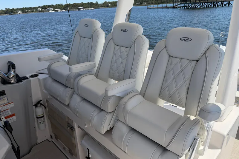 Slide: The Image of 2021 Regal 33 SAV boat interior with luxurious white seating and scenic water view. - 18