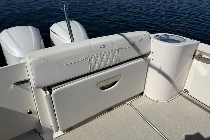 Slide: The Image of 2021 Regal 33 SAV boat interior with white seating and dual engines on water. - 24