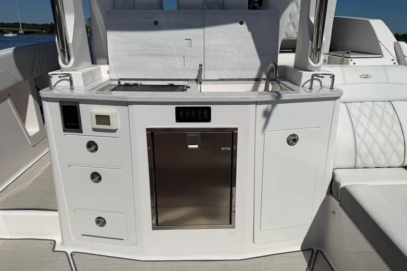Slide: The Image of 2021 Regal 33 SAV boat interior with kitchenette and storage compartments. - 25