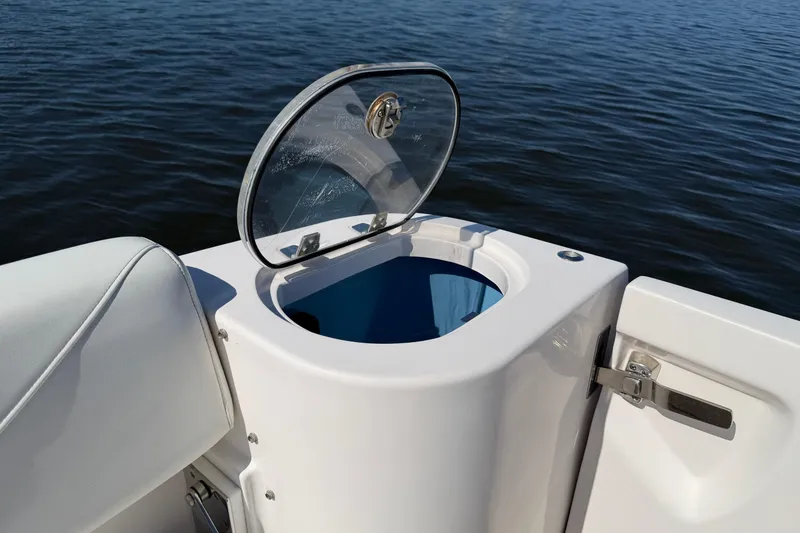 Slide: The Image of 2021 Regal 33 SAV boat with open storage compartment on calm water. - 27