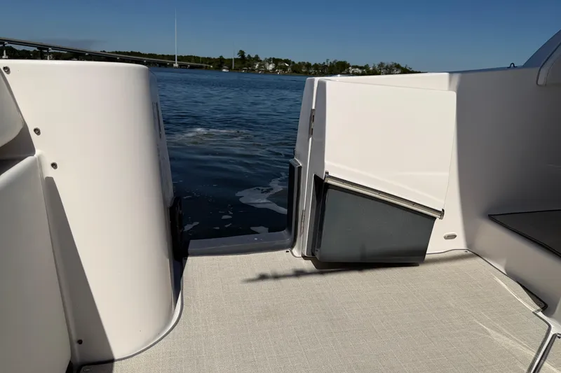 Slide: The Image of 2021 Regal 33 SAV boat interior with open door, overlooking calm water. - 28